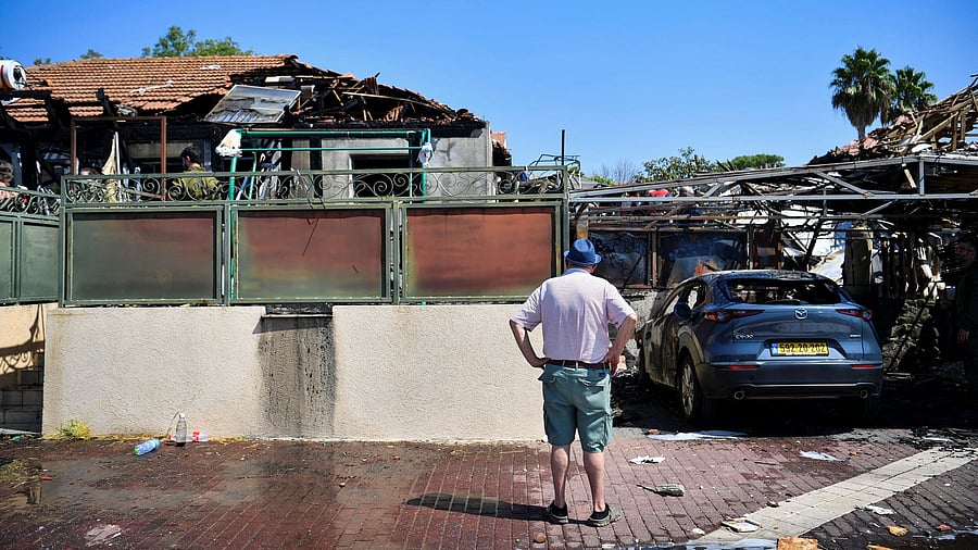 <div class="paragraphs"><p>A man looks at the damage to a house caused by rockets that were fired from Lebanon, in Katzrin in the Israeli-occupied Golan Heights</p></div>